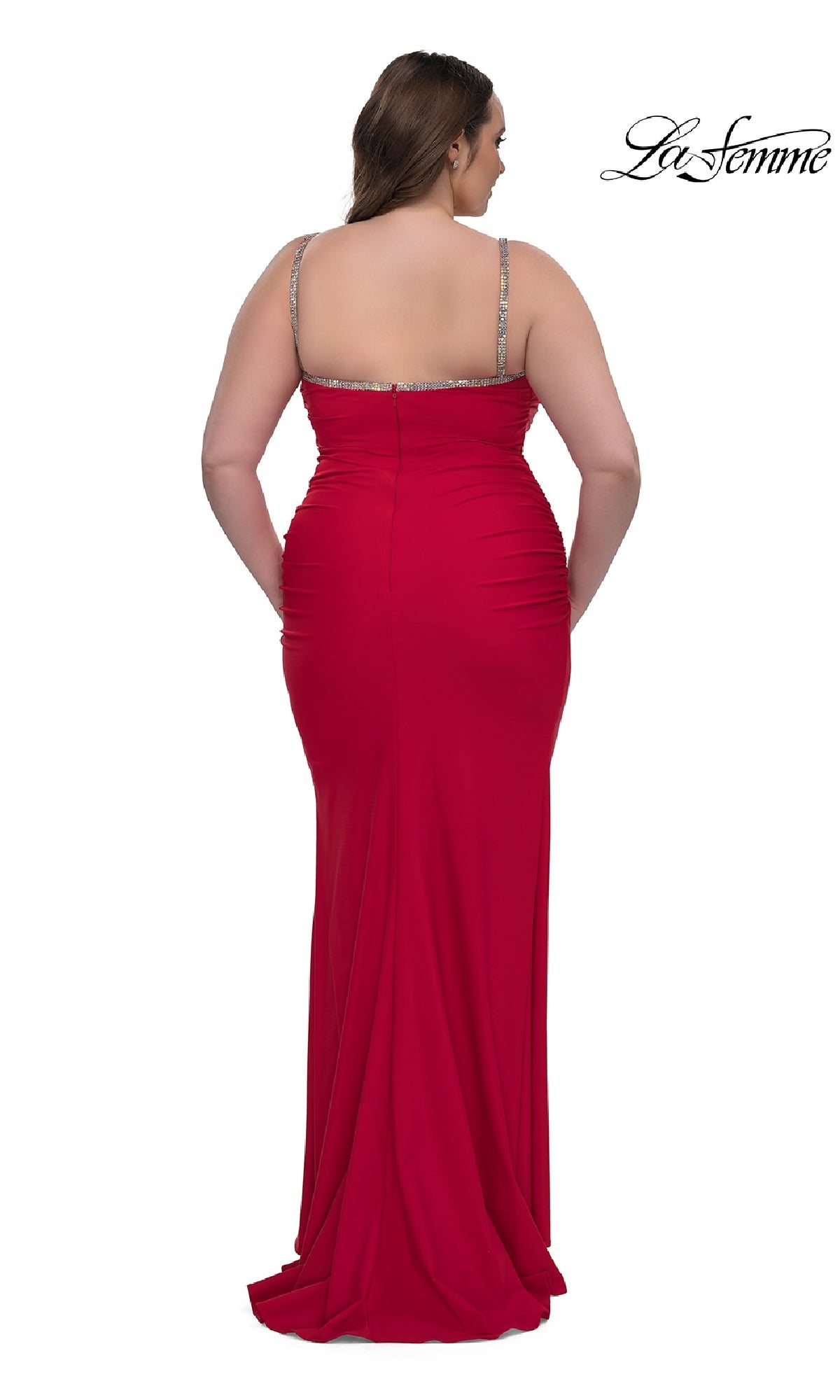 A woman wears the Plus-Size Long Prom Dress: La Femme 32992, featuring red bead-trimmed details and beaded shoulder straps, standing with her back to the camera against a white background.
